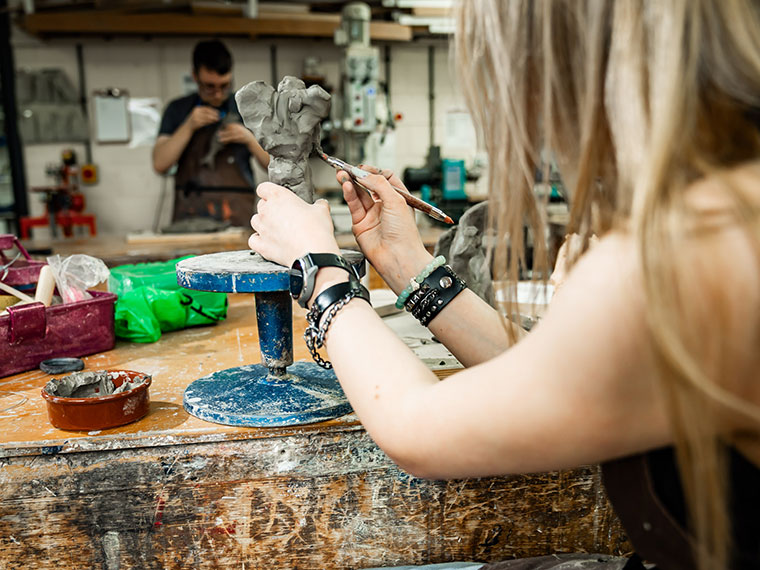 A student working on a clay model