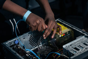 A student working on the inside of a computer