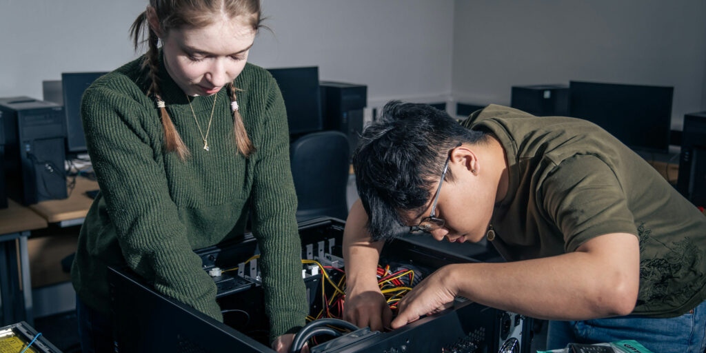 Students looking inside a computer