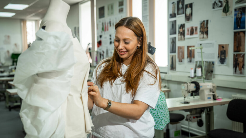 A student creating a fashion item