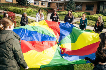 childcare students playing parachute games