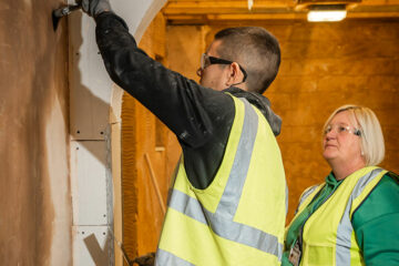 A plastering student with their lecturer