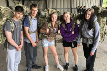 Protective Students wearing army backpacks