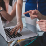 People gathered around a laptop