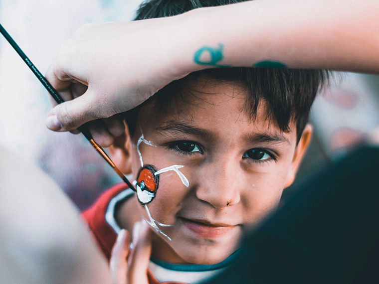 A child having their face painted