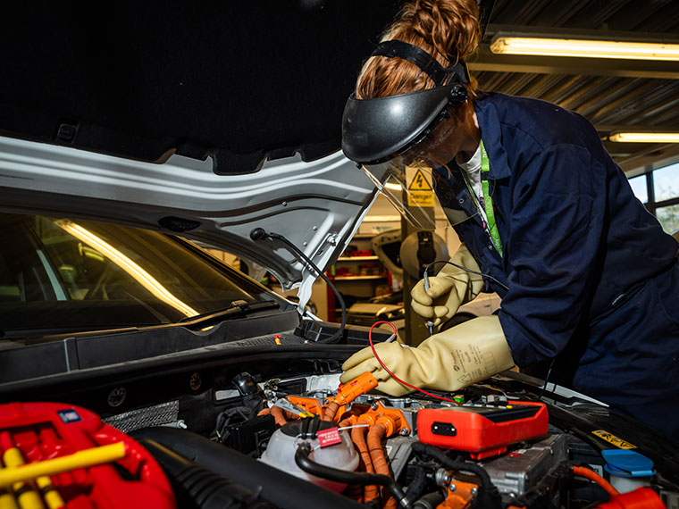 Motor Vehicle student looking under a car bonnet