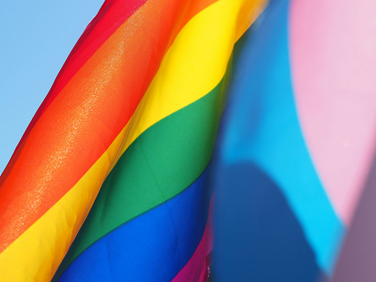 A close up shot of a rainbow coloured flag