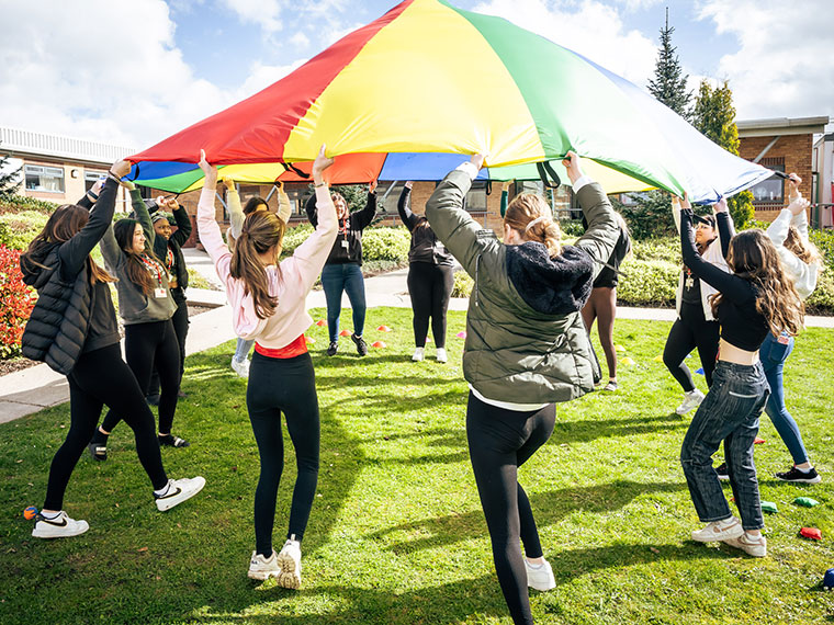 Childcare students playing parachute games