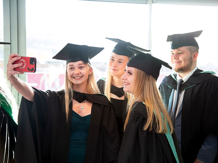 Students taking a selfie after the graduation 2023 ceremony